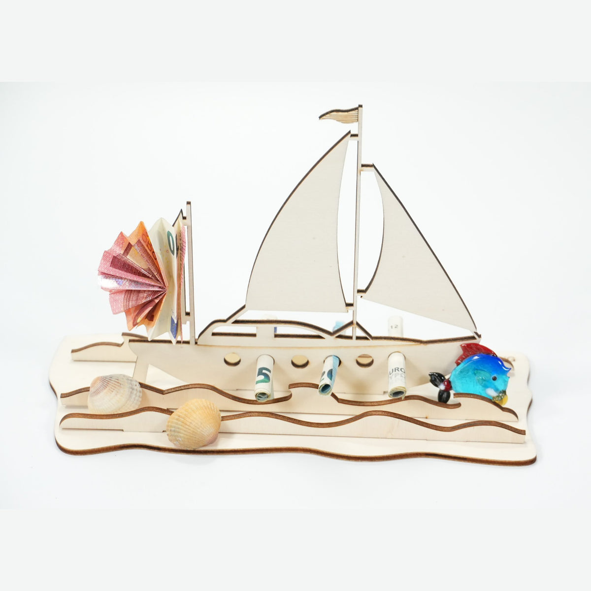 Segelboot-Geldgeschenk aus Holz mit Geldrollen, Muscheln und buntem Glasfisch